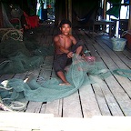 Fixing his fishingnets in a fishingvillage outside Sihanoukville