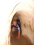 Contingue crawling in the (double:tourist size) VC tunnel at Cu Chi